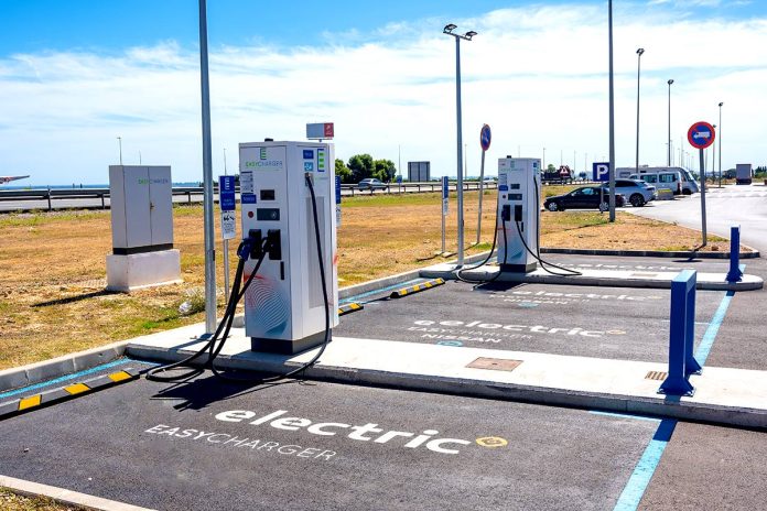 electric-car-chargers-at-a-gas-station-with-a-par-2023-11-27-05-19-37-utc