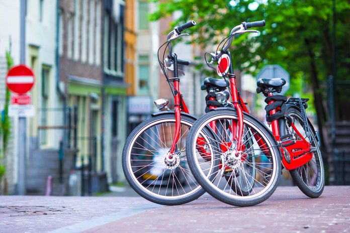 Red Bikes on old bridge in Amsterdam, Netherlands