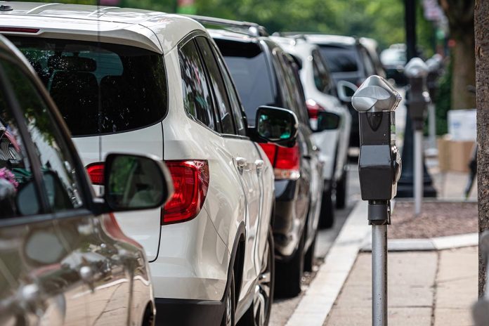 a row of parked cars on the side of the street and a parking pay