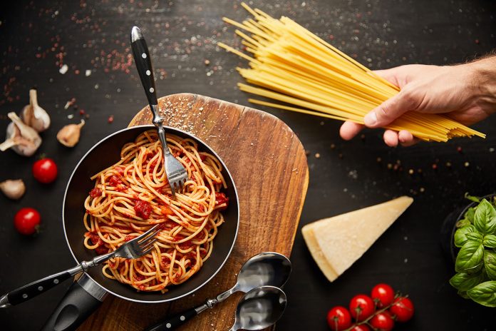 cropped-view-of-man-holding-spaghetti-near-tasty-b-2023