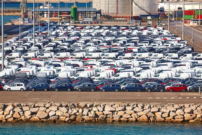 New vehicles in parking lot ready to be shipped. Vehicle product