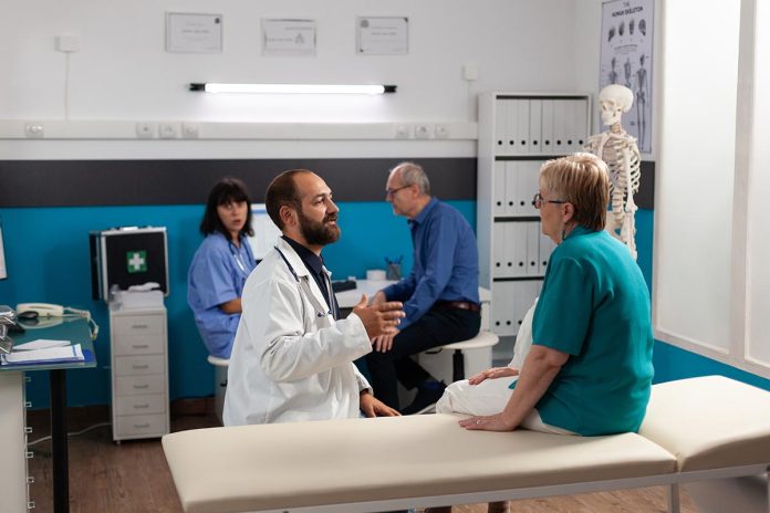 Patient with physical injury talking to doctor about recovery