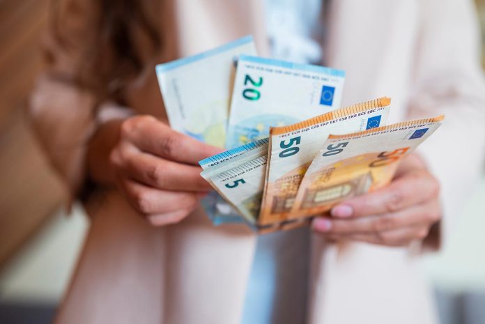 Salaries a-girl-holds-banknotes-money-euro-in-her-hands-for