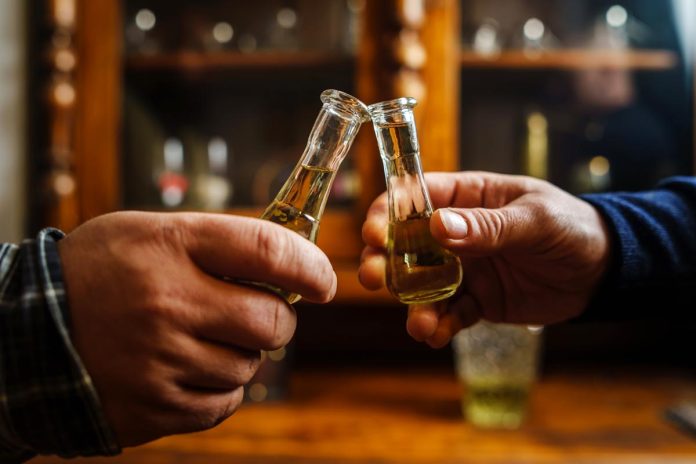 Close,Up,On,Hands,Of,Two,Unknown,Men,Toasting,With