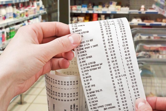 Female,Hand,Holds,The,Check,From,Supermarket