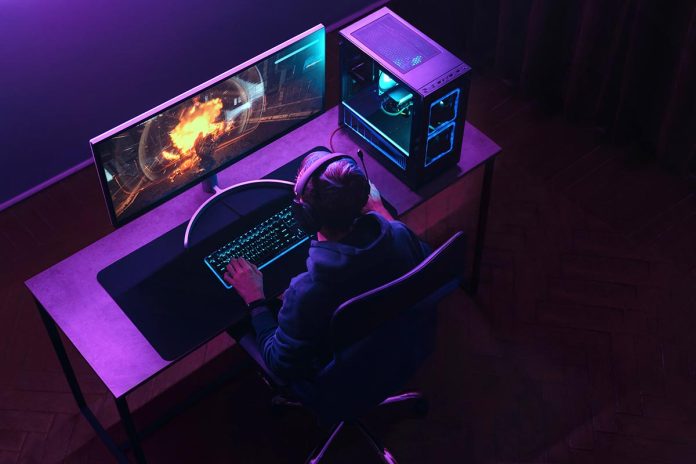Top,View,Of,Professional,Cyber,Sportsman,In,Headphones,Playing,Shooter