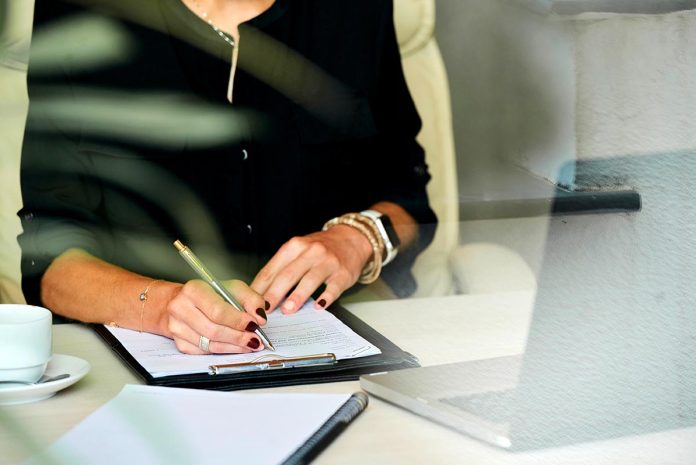 Manicured,Hands,Of,Businesswoman,Filling,Information,In,Construction,Contrat