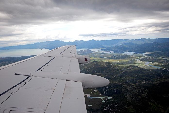 Aerial,View,By,The,Airplane,Wing,While,Flying,Above,The