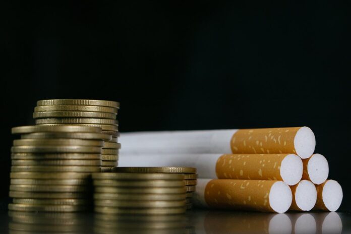 Cigarettes.Tobacco Cigarettes and money coins.Cigarettes and TAX