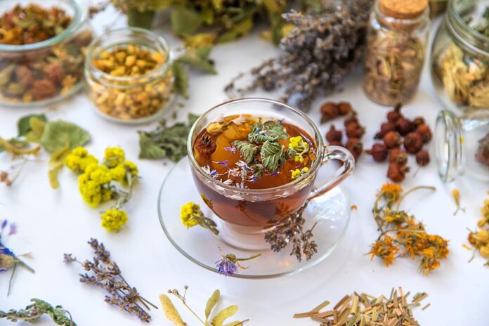 Herbal tea with medicinal herbs and flowers. Selective focus.