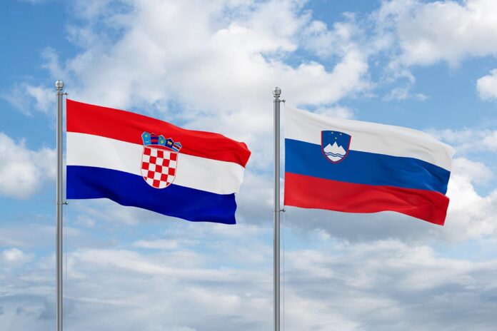 Slovenia,And,Croatia,Flags,Waving,Together,In,The,Wind,On