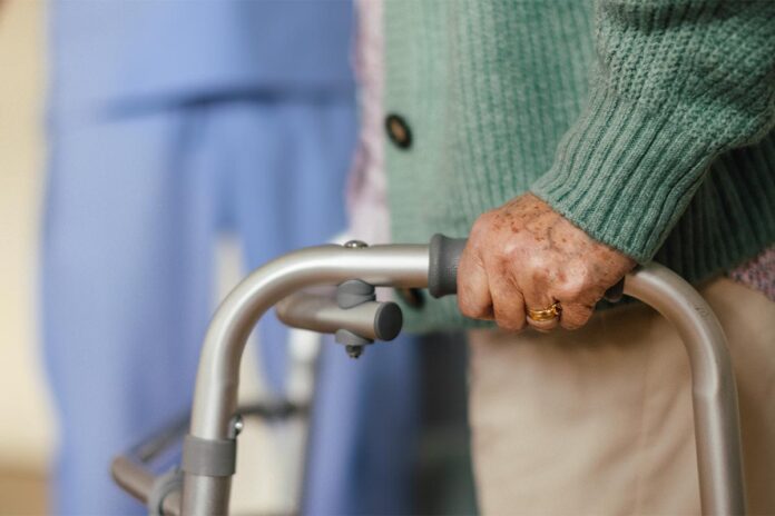 Close up of senior woman with walker.