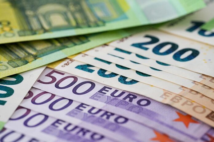 Heap of Euro banknotes on a table - business and investment concept