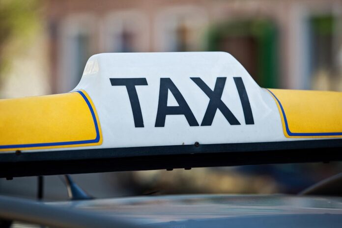 Taxi sign on a car roof - close-up