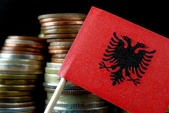 Albanian,Flag,Waving,With,Stack,Of,Money,Coins,Macro