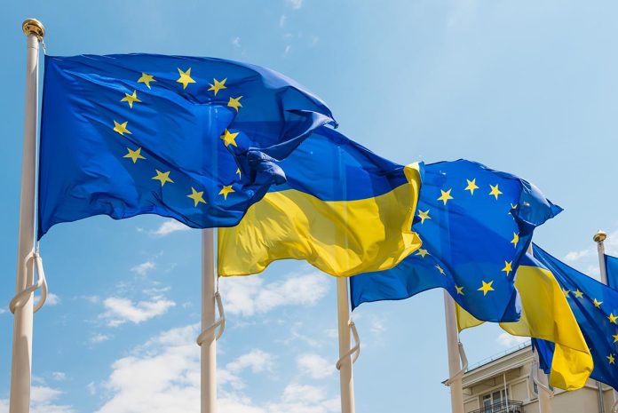 Ukraine,And,European,Union,Flags,On,Poles,Fluttering,By,Wind