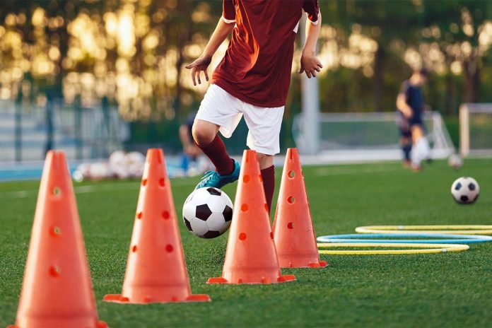 Boys,Running,Soccer,Balls,Between,Training,Cones.,European,Football,Sports