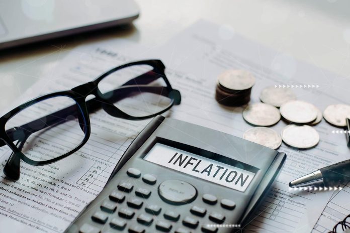 Inflation word on calculator with interest rate hike considerati