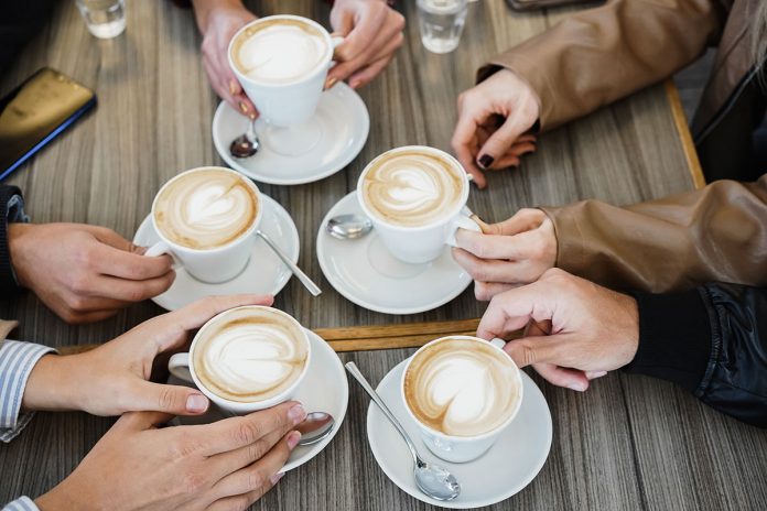 group-enjoying-coffee-drinks-together-at-table-2026-01-08-05-40-48-utc