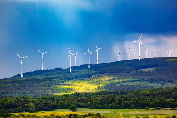 Mesmerizing shot of wind turbines under a cloudy sky