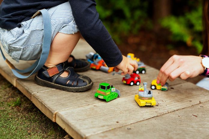 Playtime in the backyard with colorful toy cars.