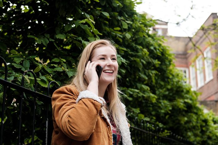 Portrait of young woman using her phone.